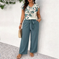 👗✨ V-ringad jumpsuit med vida ben och midjebälte