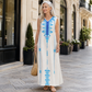 👗🌿 Elegant resort maxiklänning med V-hals och statement-print