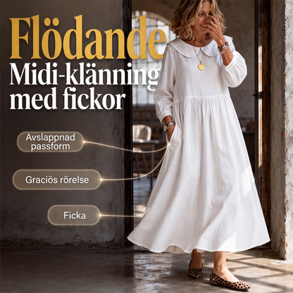 Damig löst sittande långärmad maxiklänning med fickor
